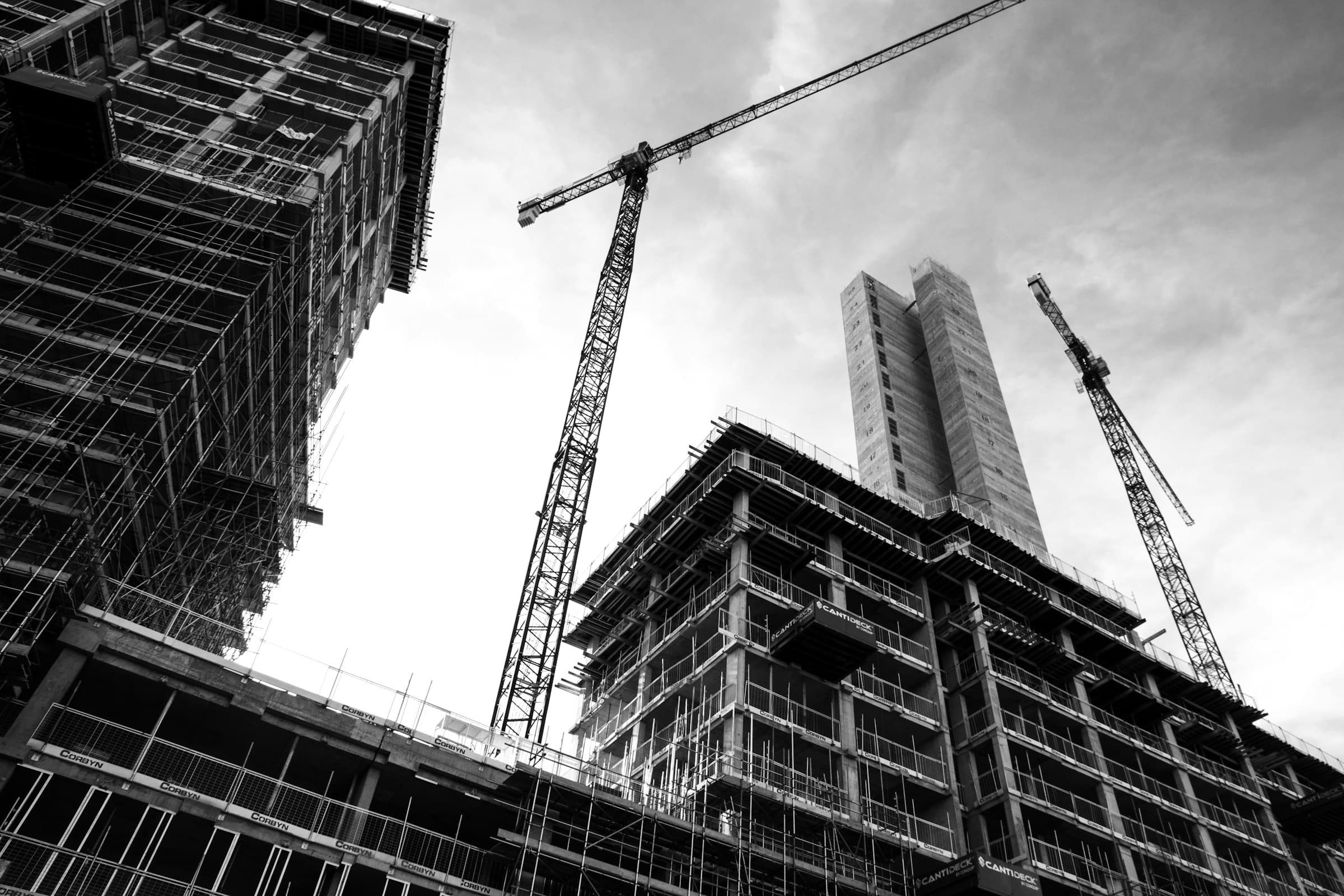 Commercial building construction site with cranes and scaffolding