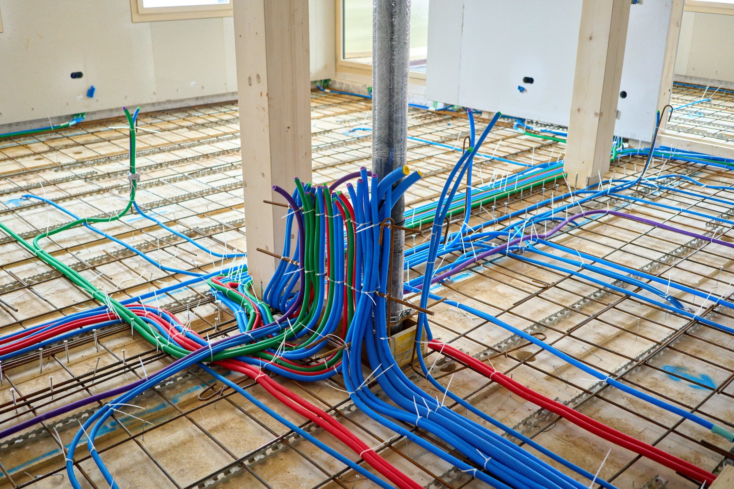 Electrical wiring and plumbing pipes installation at construction site