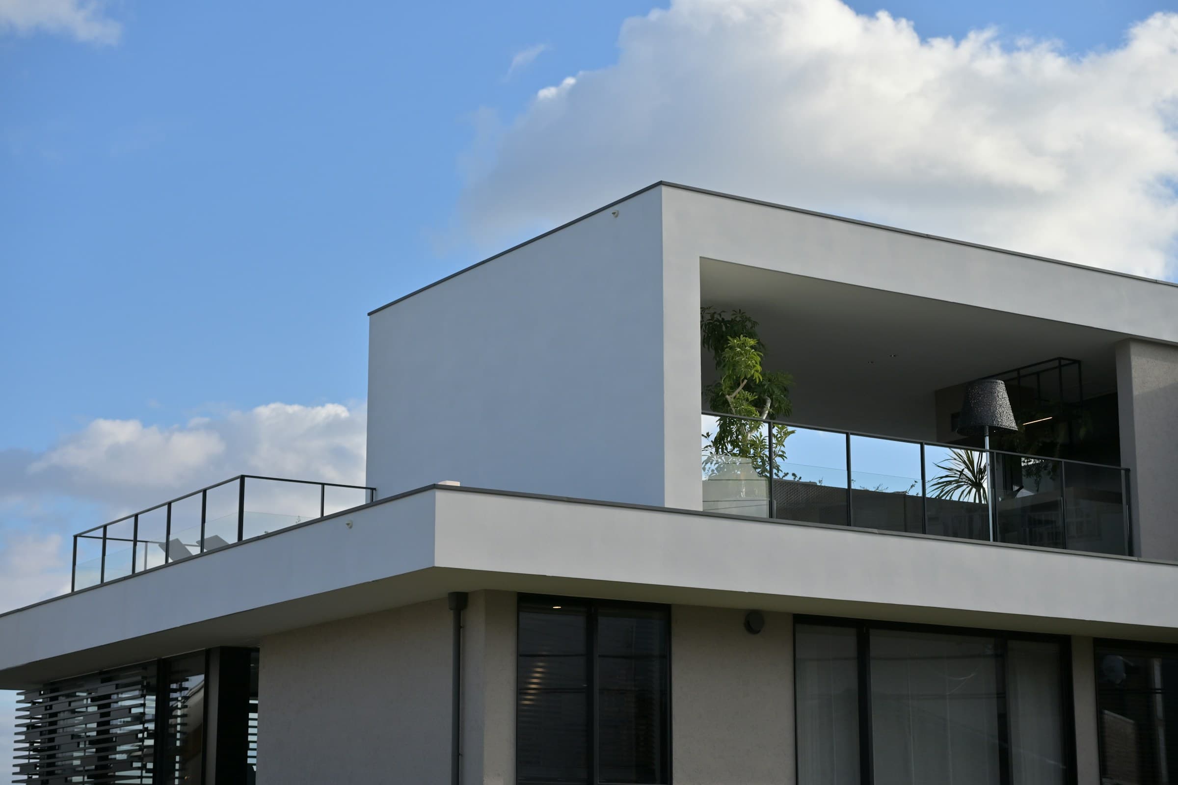 Modern villa under construction with scaffolding and clear blue sky